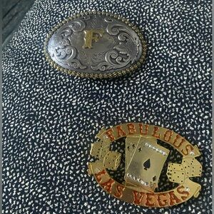 2 very cool belt buckles.  One with the initial F. The other Fabulous Las Vegas